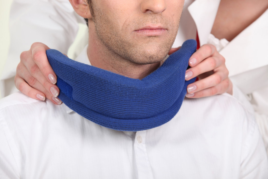 doctor puts neck support brace